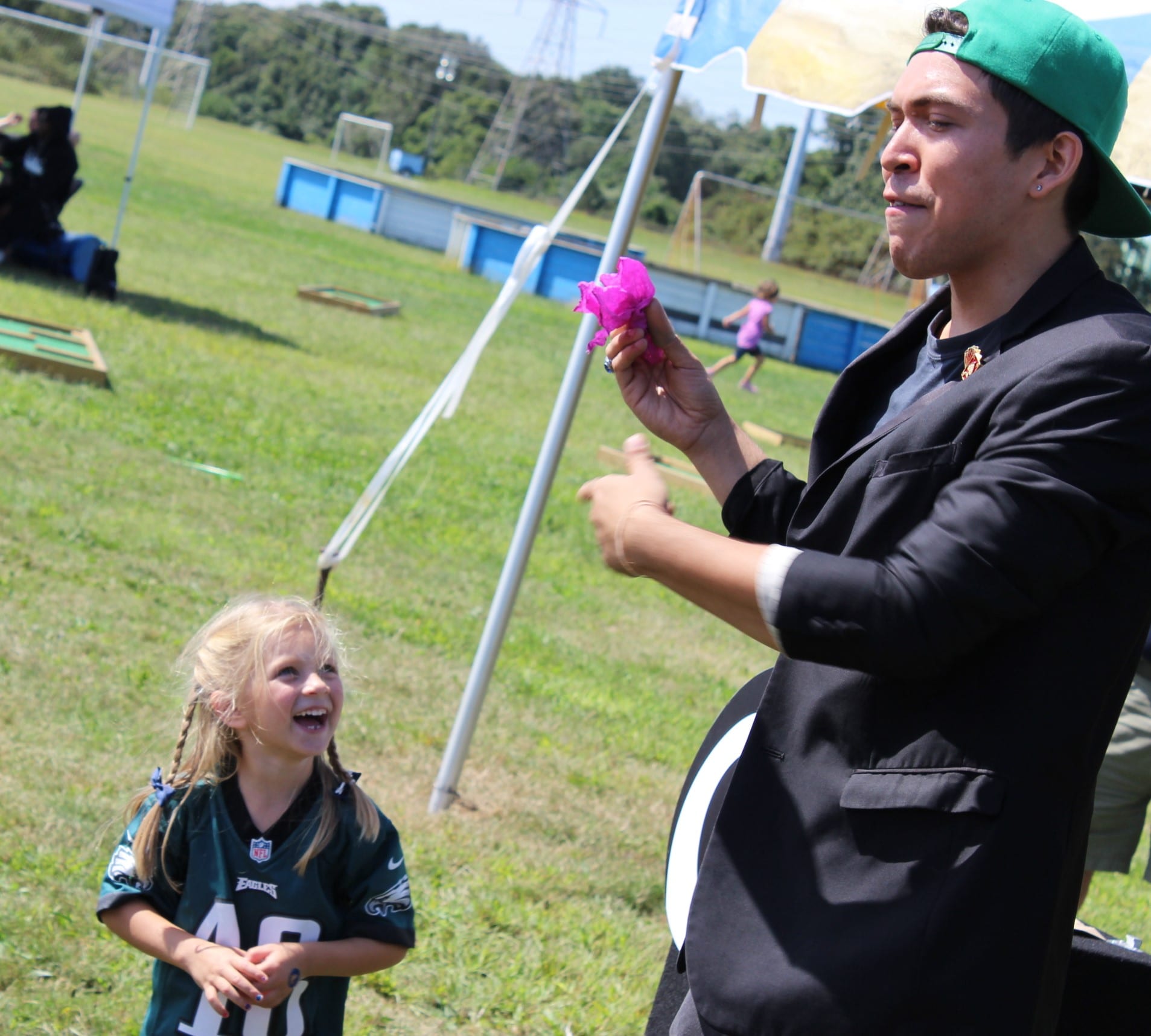 A girl delighted by a magic ball trick