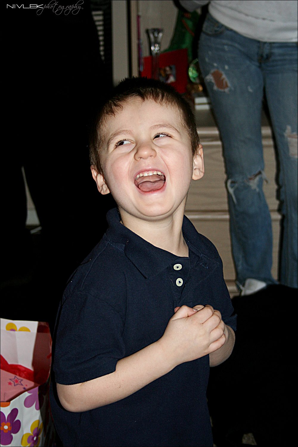 A boy doubled over laughing