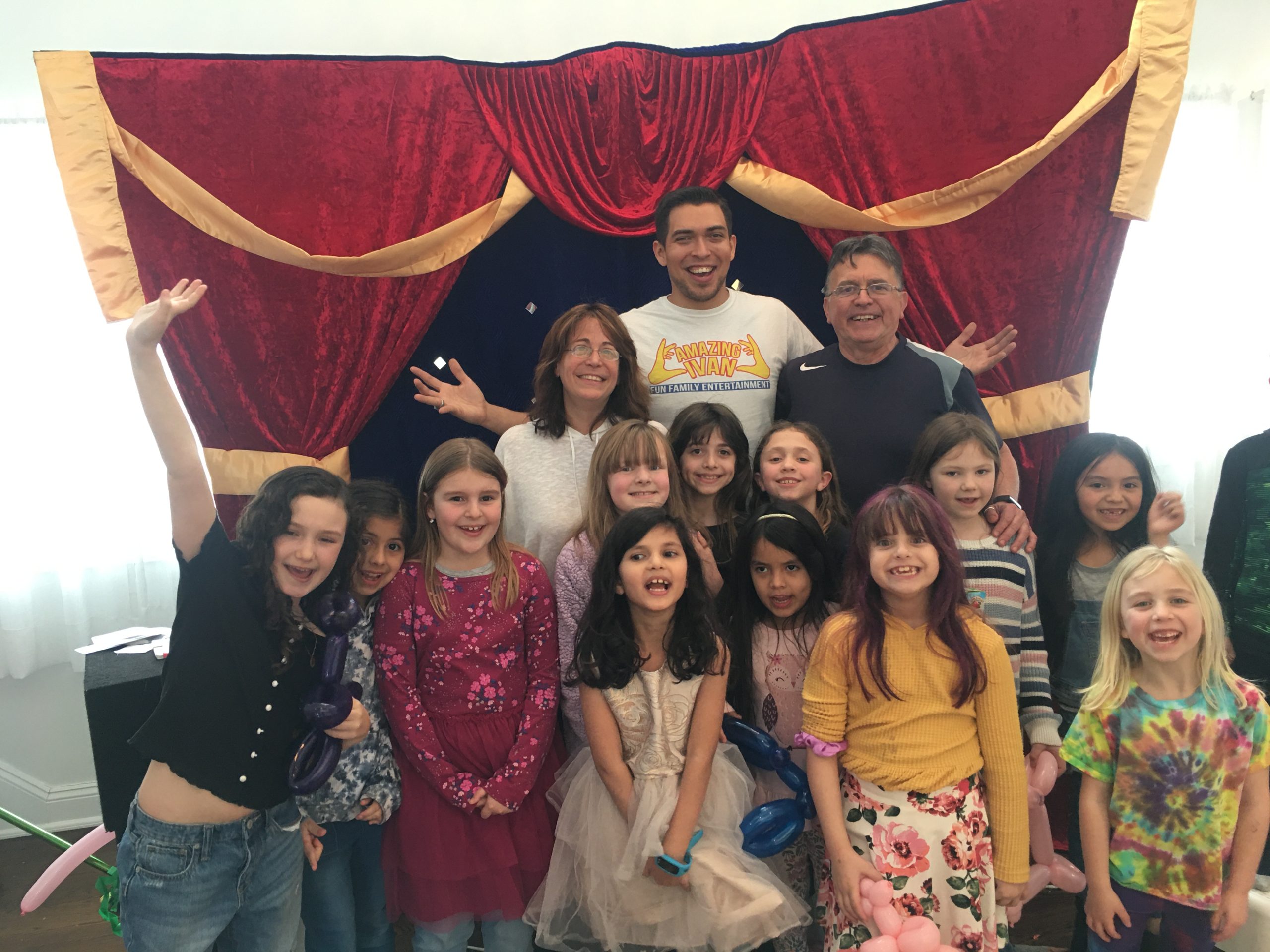 A smiling family behind the curtain